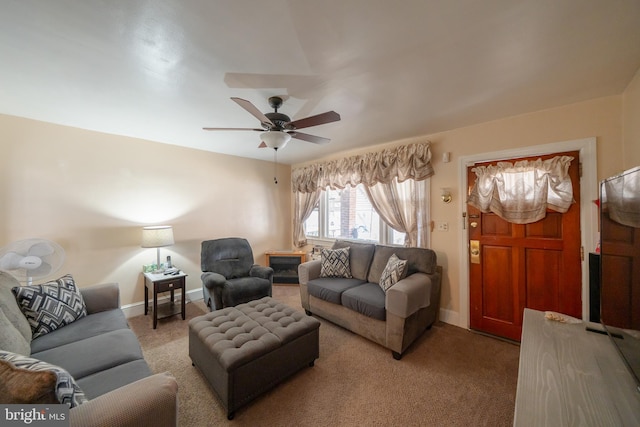 living area with light colored carpet, baseboards, and ceiling fan