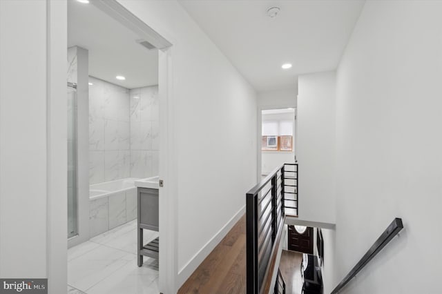 hall with marble finish floor, recessed lighting, visible vents, an upstairs landing, and baseboards