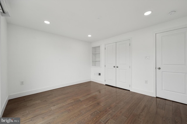 unfurnished bedroom with a closet, baseboards, dark wood-type flooring, and recessed lighting