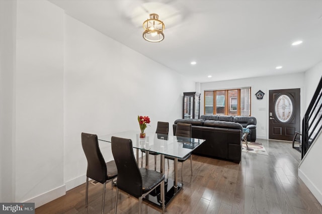 dining area featuring recessed lighting, stairway, baseboards, and wood finished floors