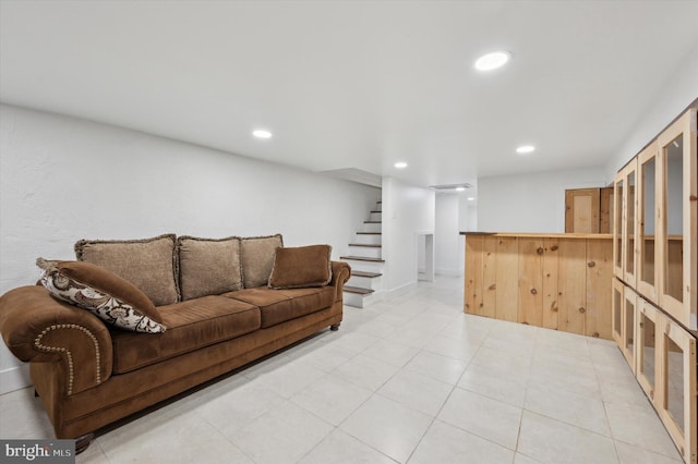 living room with recessed lighting, stairway, and light tile patterned floors