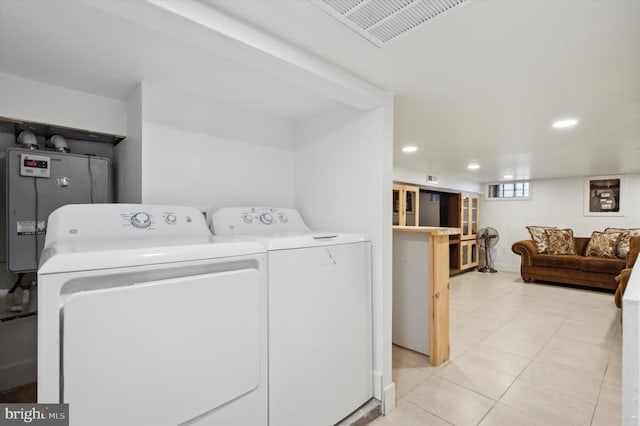 washroom with laundry area, visible vents, water heater, separate washer and dryer, and recessed lighting