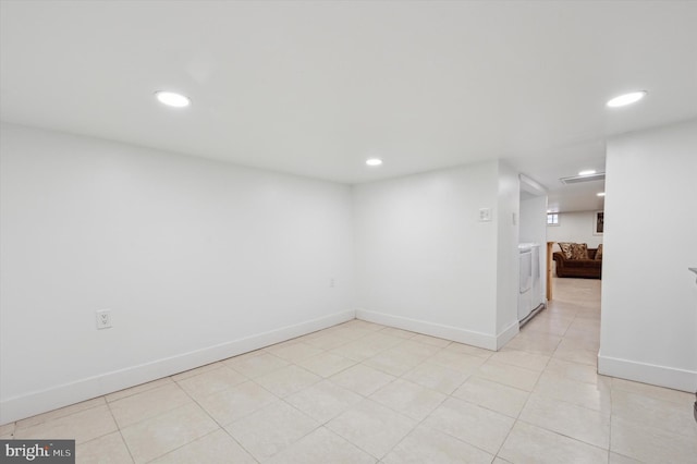 spare room with recessed lighting, baseboards, and light tile patterned floors