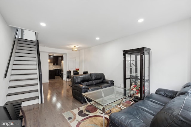 living room featuring stairs, wood finished floors, and recessed lighting