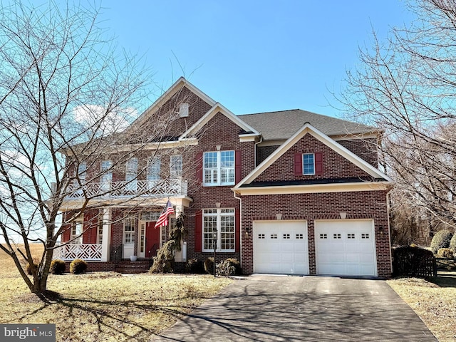 view of front of home featuring driveway, brick siding, and an attached garage