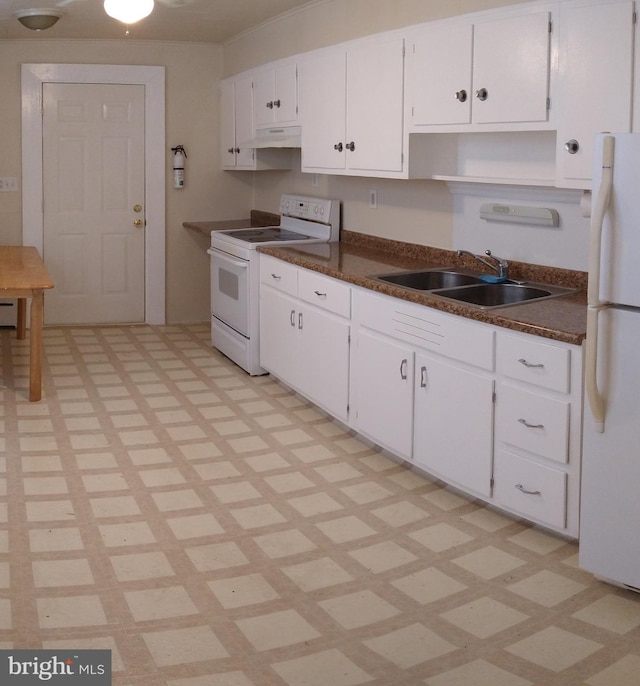 kitchen featuring dark countertops, white appliances, and white cabinetry