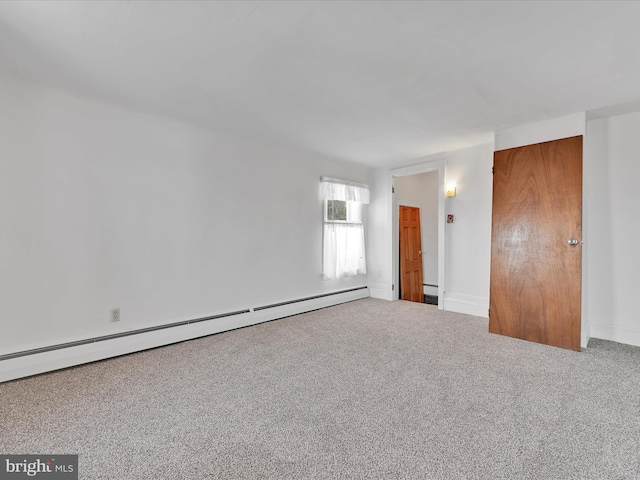 spare room with a baseboard radiator and carpet flooring