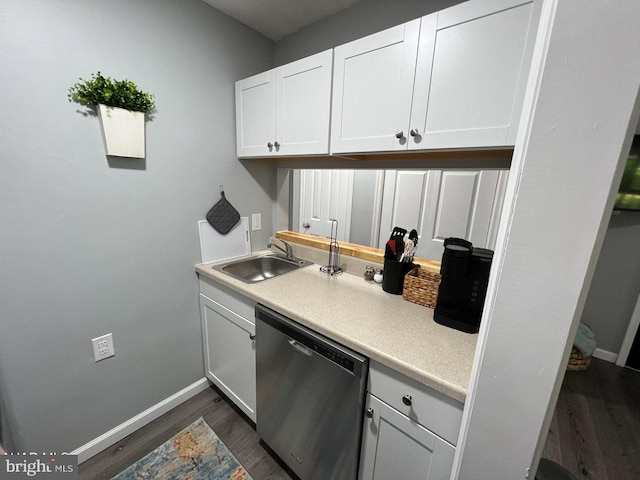 kitchen with dark wood finished floors, white cabinets, dishwasher, light countertops, and a sink