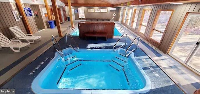 view of pool featuring a wall unit AC and an indoor hot tub