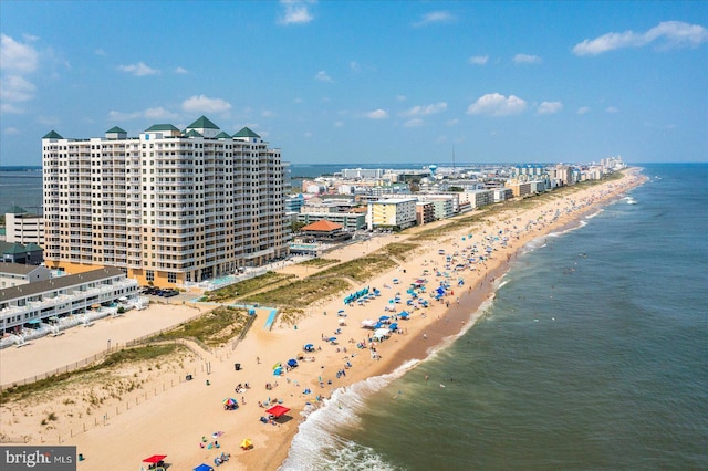 birds eye view of property featuring a water view, a view of city, and a view of the beach