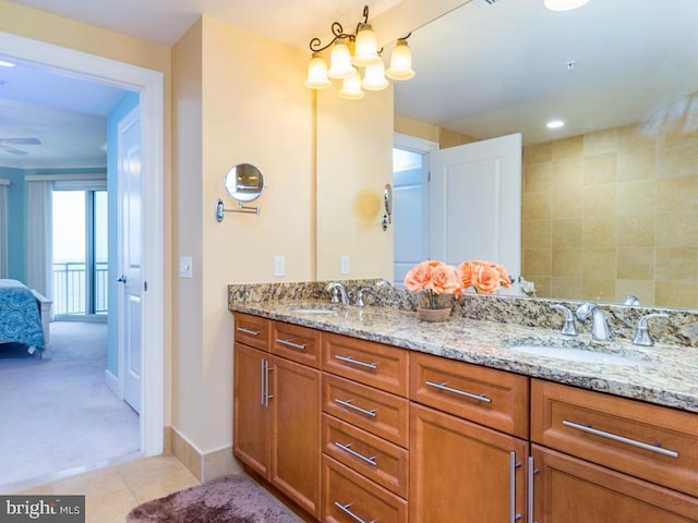 full bath with tile patterned flooring, connected bathroom, a sink, and double vanity