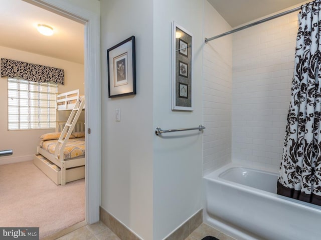 bathroom featuring tile patterned flooring, baseboards, and shower / tub combo with curtain