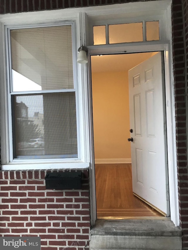 property entrance with brick siding