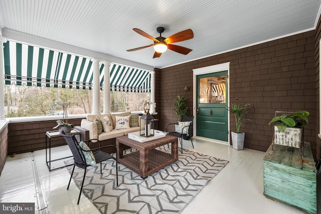 sunroom featuring a ceiling fan