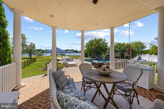 view of patio featuring a fenced in pool, fence private yard, and outdoor dining area