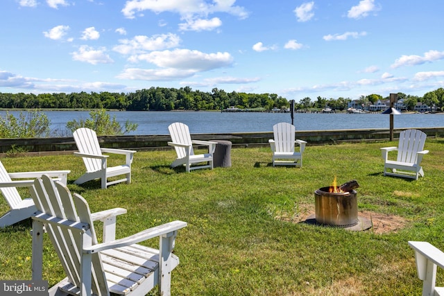 view of yard with a fire pit and a water view