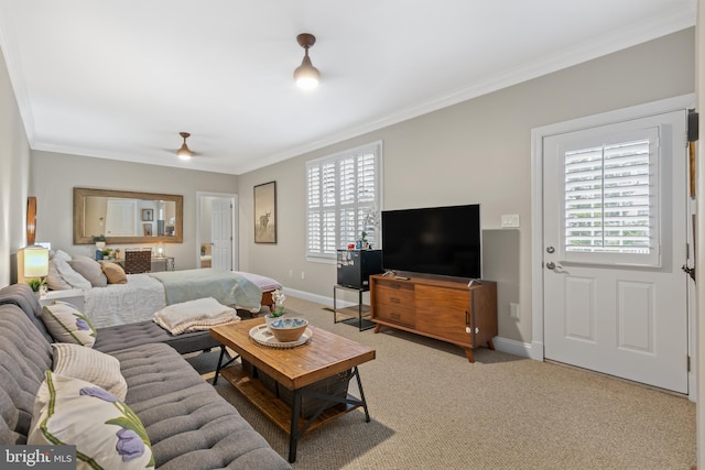 living room with ornamental molding, light colored carpet, ceiling fan, and baseboards