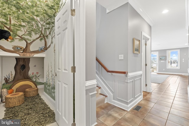 corridor featuring ornamental molding, stairway, light tile patterned flooring, and visible vents