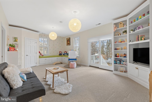 carpeted living area with visible vents and baseboards