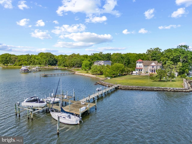 dock area featuring a water view, a lawn, and boat lift