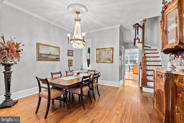 dining space with stairway, ornamental molding, a chandelier, light wood-type flooring, and baseboards