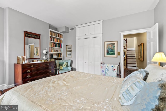 bedroom with a closet and visible vents