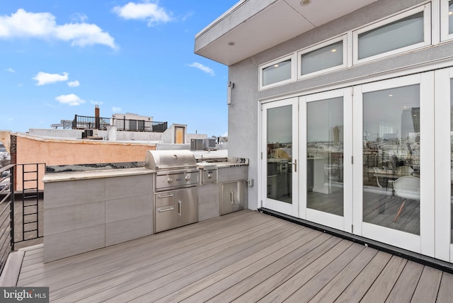 deck featuring french doors, area for grilling, and central AC unit