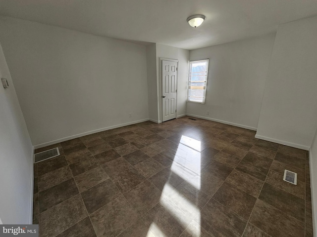 empty room with visible vents and baseboards