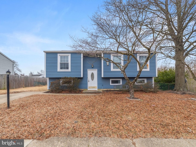 raised ranch with entry steps and fence