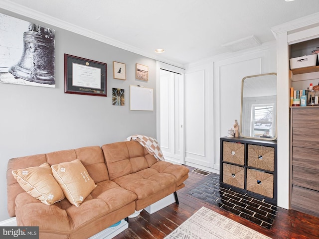 living room with wood-type flooring and crown molding