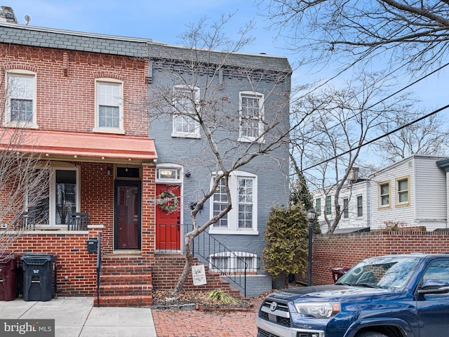 townhome / multi-family property featuring brick siding