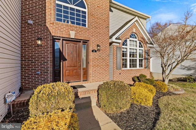 property entrance with brick siding