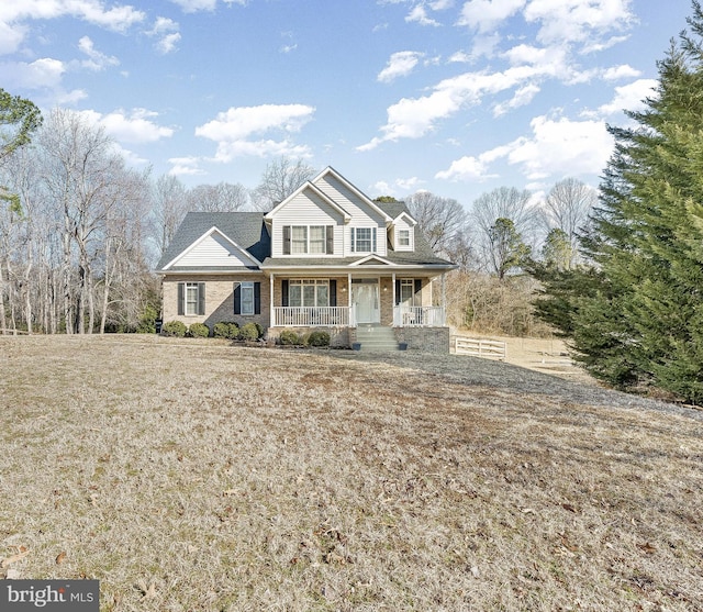 view of front of house with a porch and brick siding