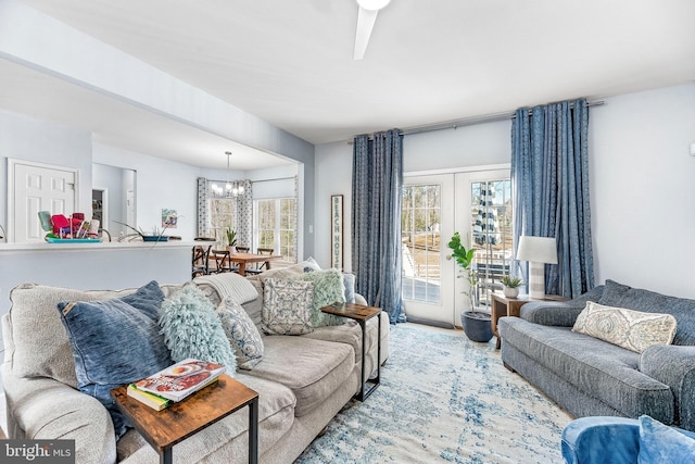 living room featuring a notable chandelier and french doors