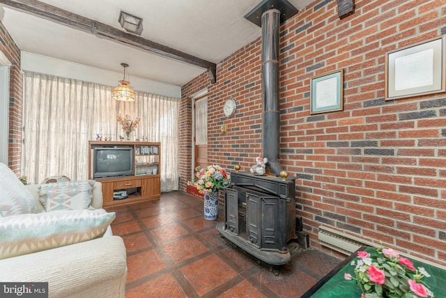 living area with a wood stove, visible vents, beamed ceiling, and brick wall