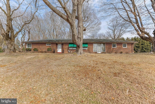 single story home with a front lawn and brick siding