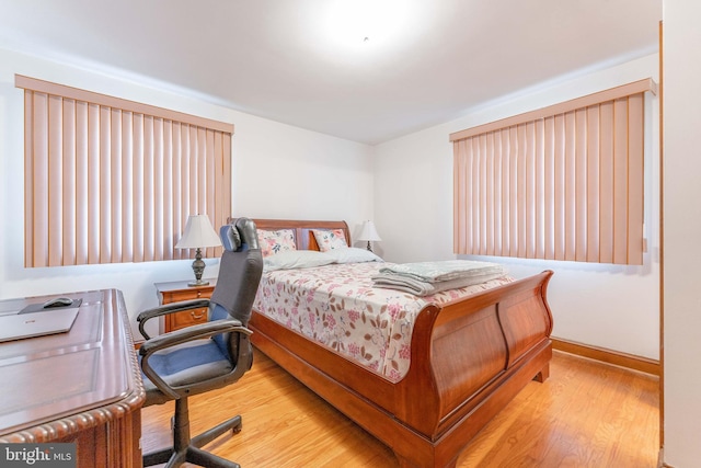 bedroom featuring baseboards and wood finished floors