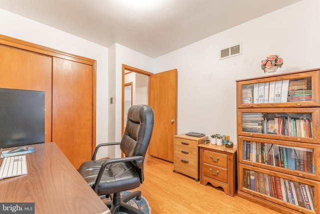 office space featuring visible vents and light wood-style flooring