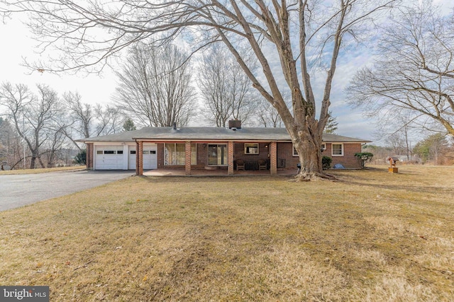 ranch-style house with a garage, brick siding, aphalt driveway, a porch, and a front yard