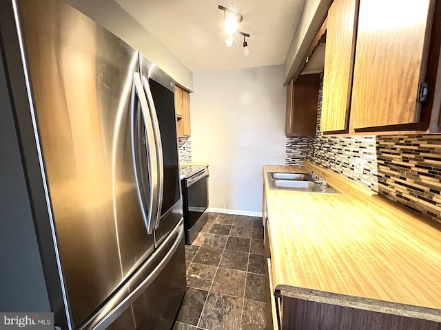 kitchen with tasteful backsplash, stainless steel appliances, and a sink