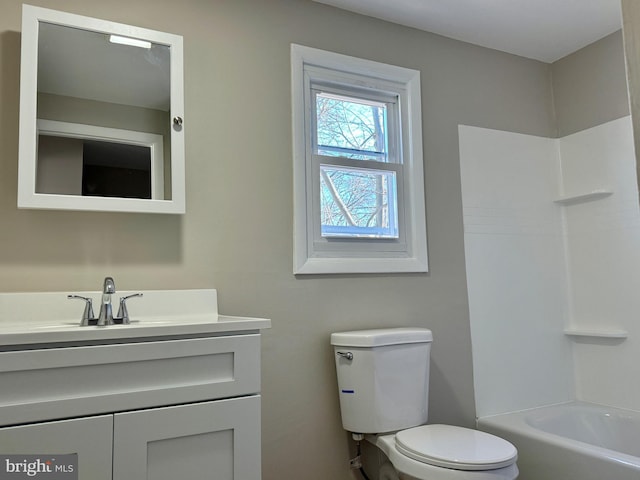 bathroom with shower / bath combination, vanity, and toilet