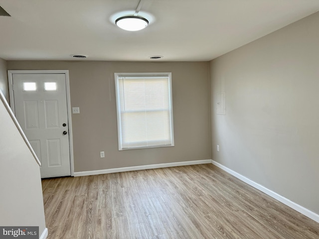 entrance foyer with light wood-style floors, visible vents, and baseboards