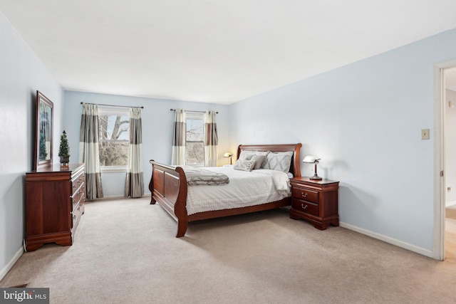 carpeted bedroom featuring baseboards