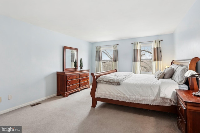 bedroom featuring carpet floors, visible vents, and baseboards