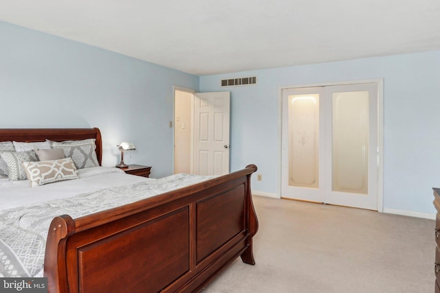 bedroom with baseboards, visible vents, and light colored carpet