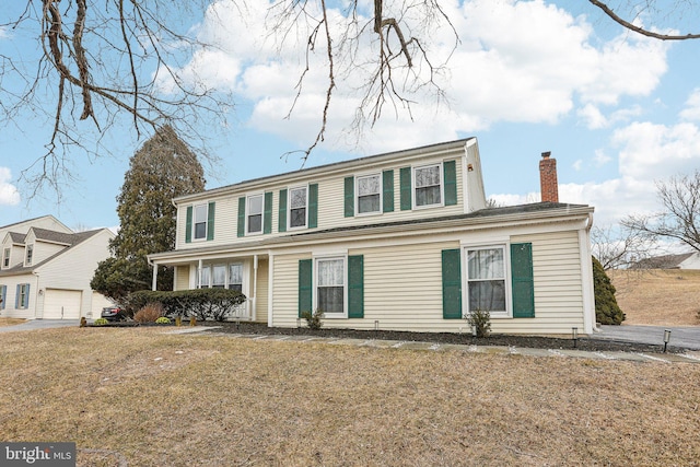 view of front of house with a chimney and a front yard