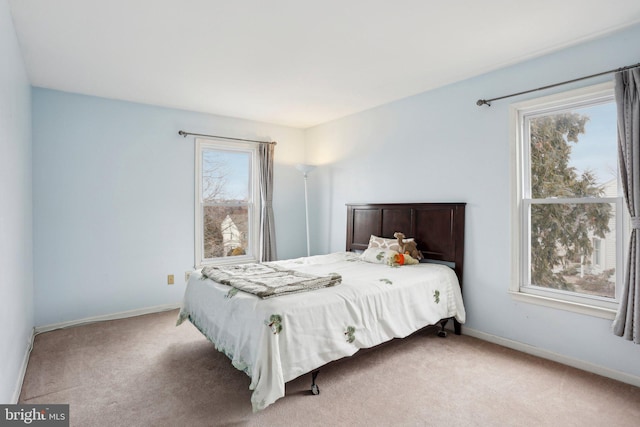 bedroom featuring multiple windows, carpet flooring, and baseboards