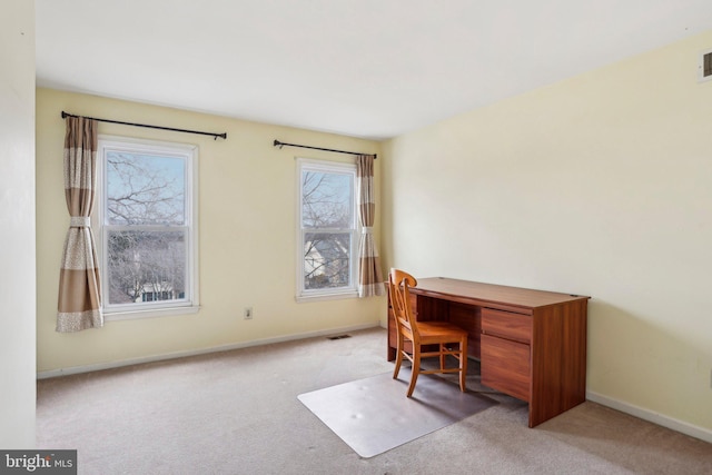 carpeted office featuring visible vents and baseboards