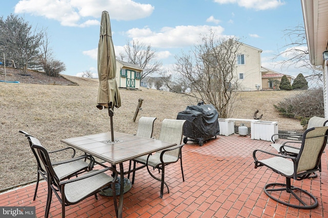 view of patio with outdoor dining space and grilling area