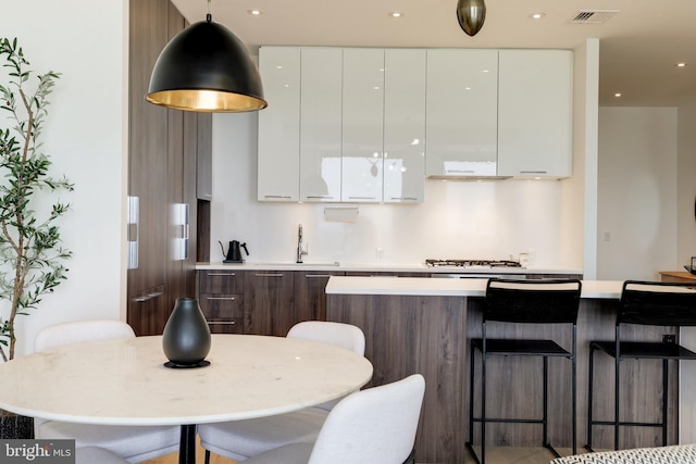 kitchen with light countertops, modern cabinets, and white cabinetry